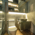 Bathroom with a vessel basin, LED-lit mirror cabinet and glass shower