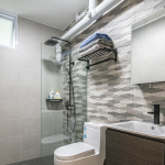 Bathroom with a textured tile feature wall and rain shower