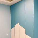 Blue painted feature wall with peach geometric shapes