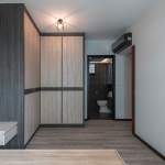 Corridor lined with built-in wardrobes in a timber-look finish