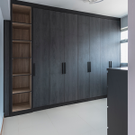 Full-height built-in wardrobe in a dark finish
