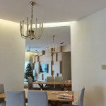 Dining room with a gold chandelier above the dining table
