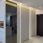 Entryway with white fluted panels, LED strip lights and a mirror