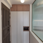 Entryway with a tall white shoe cabinet and a frosted glass panel