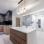 Kitchen island with pendant lights opening onto the living area