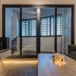 Living room with glass sliding doors to the balcony and timber flooring