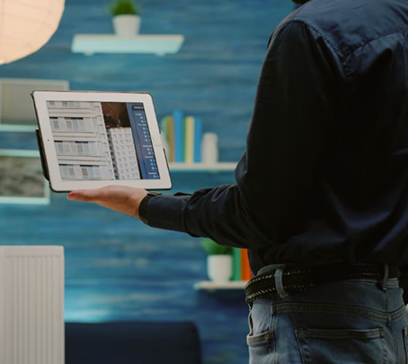 Person holding a tablet showing a design layout