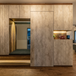 Full-height timber-look feature wall with a lit display niche