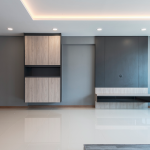 TV feature wall with grey and timber cabinetry under a cove-lit ceiling