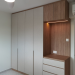 Full-height white wardrobe with timber accents and drawers