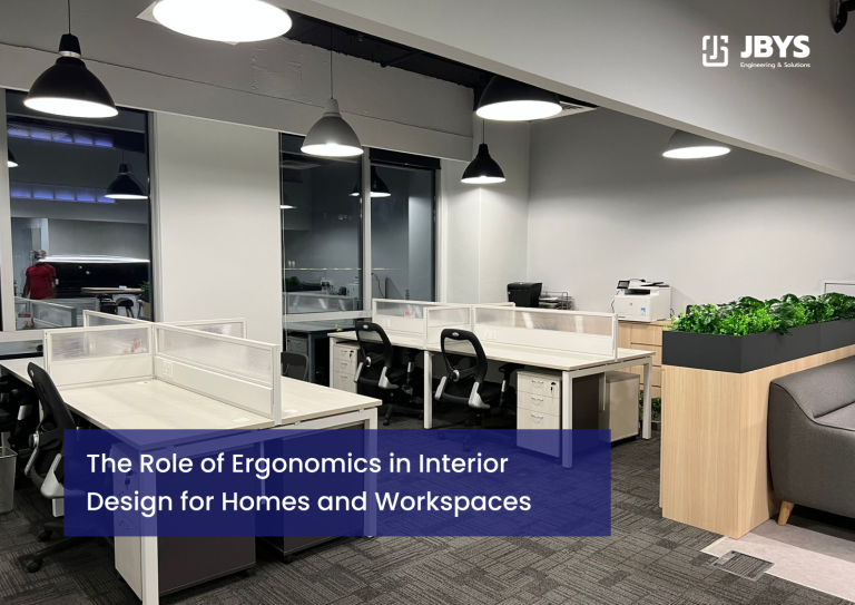 Interior view of an open-plan office space featuring rows of clean white workstations with ergonomic office chairs, privacy dividers, filing cabinets, and overhead pendant lights against grey carpeting
