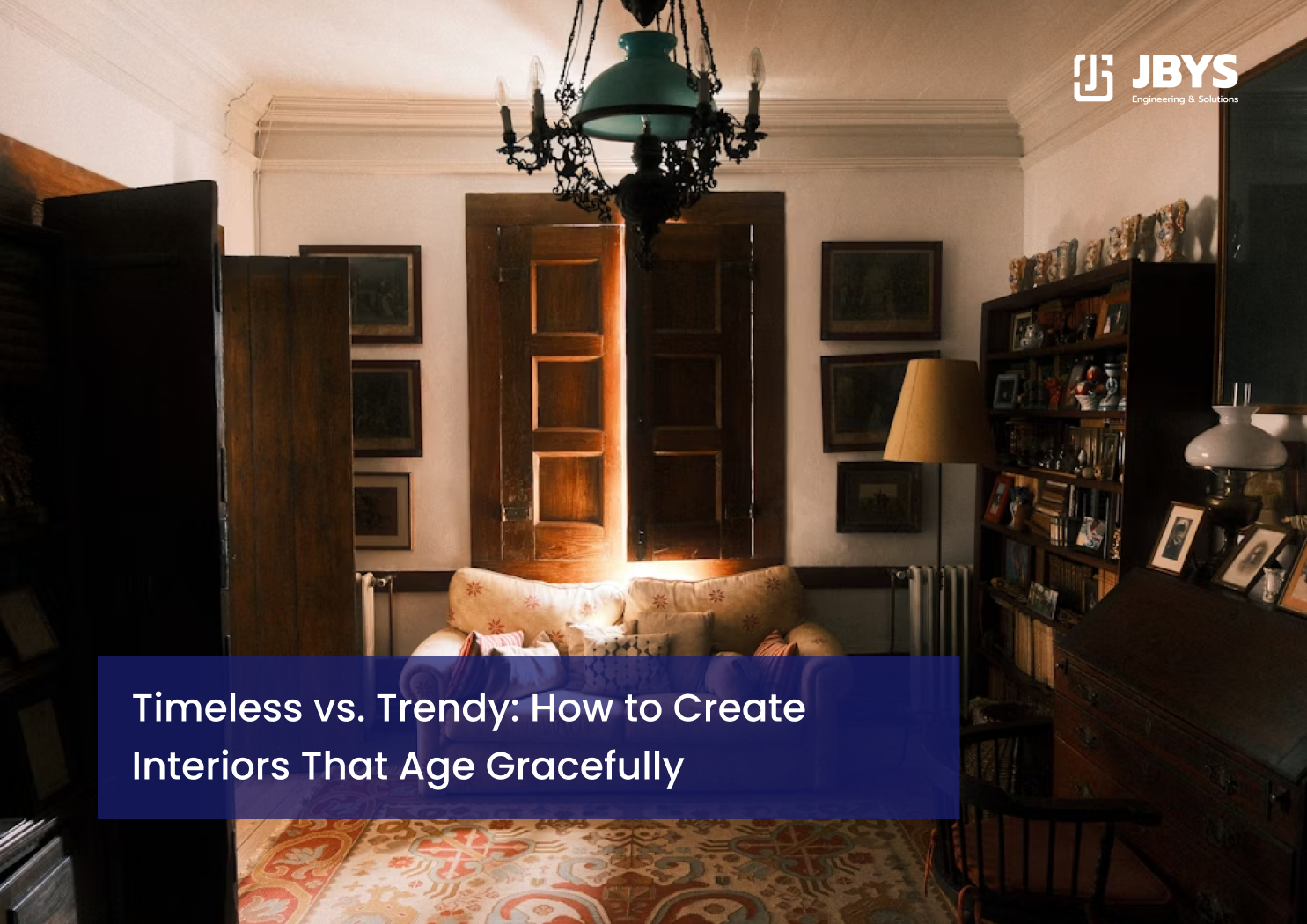 Classic study with dark timber shelving, an armchair and a chandelier