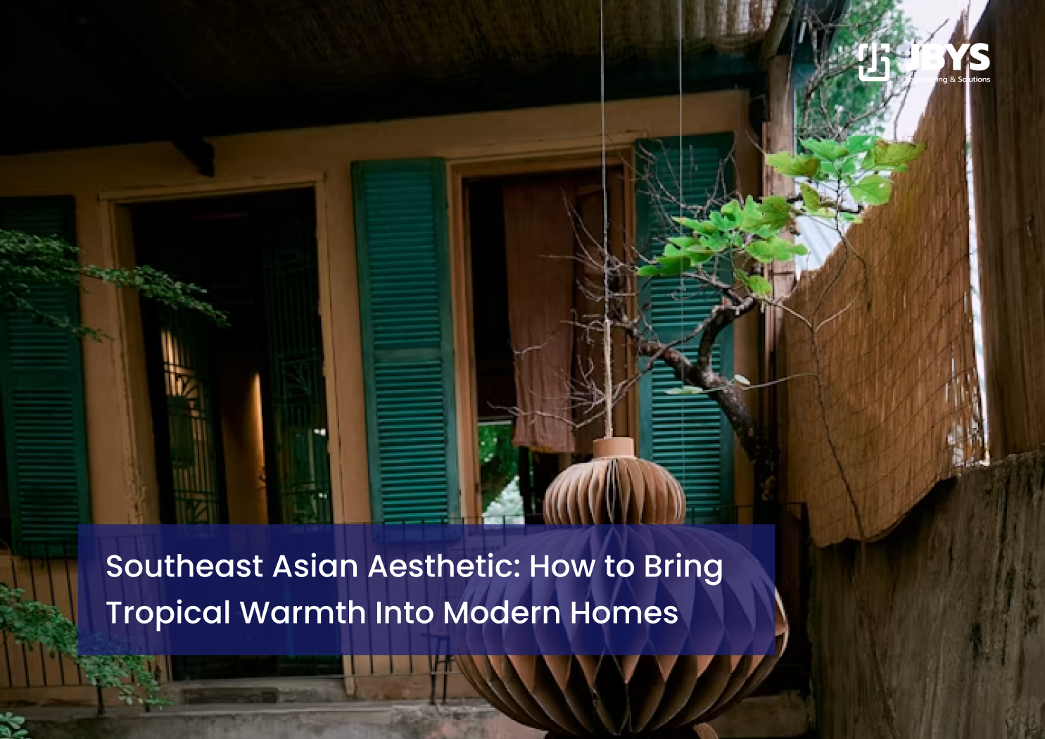Exterior view of a Southeast Asian home featuring teal wooden shutters and a decorative pendant light fixture.