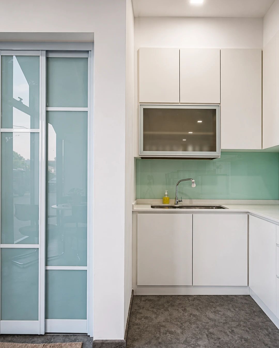 Modern open-plan office fit-out with white workstations, black chairs and planter dividers