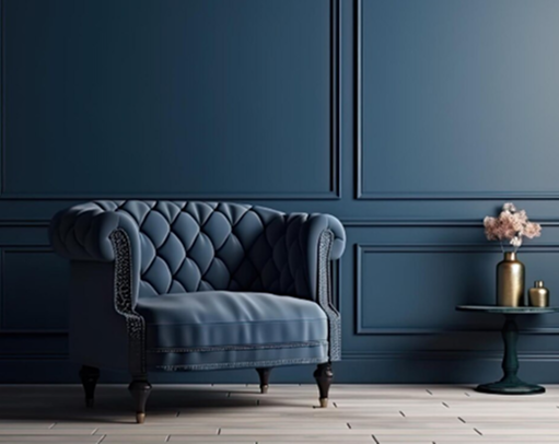 Navy tufted armchair against dark panelled walls